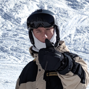 Clear Choice: Person wearing a snow jacket, helmet, and goggles, giving a thumbs-up gesture against a snowy background.